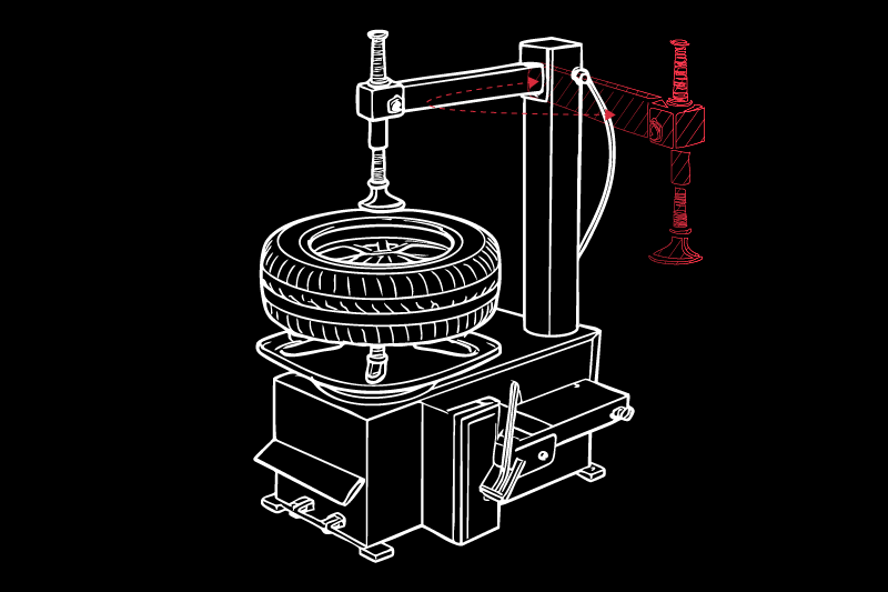 Dibujo esquemático blanco sobre fondo negro de una máquina desmontadora de neumáticos con neumático montado en plato giratorio, columna vertical y brazo con palanca; componente articulado resaltado en rojo a la derecha
