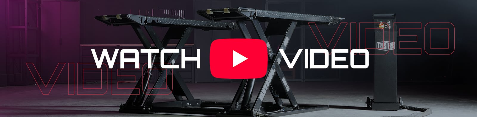 Scissor lift platform in a dim industrial space with large red play button overlay and WATCH VIDEO text, purple lighting on the left and a black control column on the right