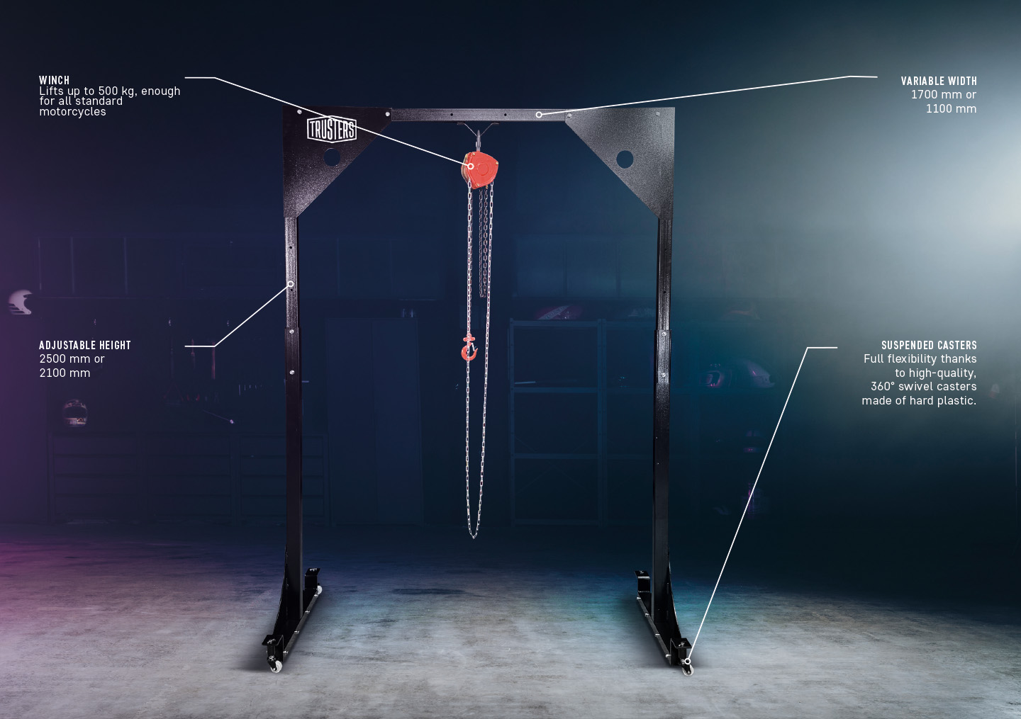 Black adjustable gantry crane with red chain hoist centered between two vertical steel posts on caster bases, set on a concrete workshop floor with dim shelving in background; annotated labels show winch capacity, adjustable height, variable width and sus