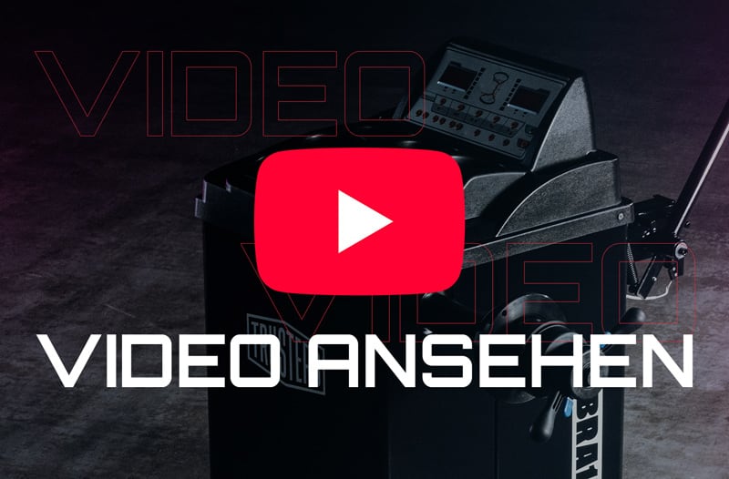 Schwarze Werkstattmaschine vor dunklem Hintergrund, überlagert von großem roten YouTube-Play-Symbol und weißer Schrift VIDEO ANSEHEN