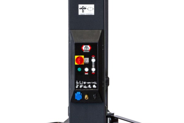 Vertical dark equipment column with control panel featuring a red emergency stop, green and white buttons and indicator lights, pictogram labels, a blue connector and a brass fitting at the bottom