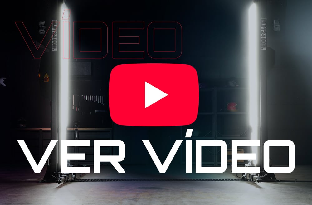Icono de reproducción rojo tipo YouTube centrado sobre fondo oscuro de taller con dos columnas de luz verticales, texto grande blanco VER VÍDEO en primer plano.