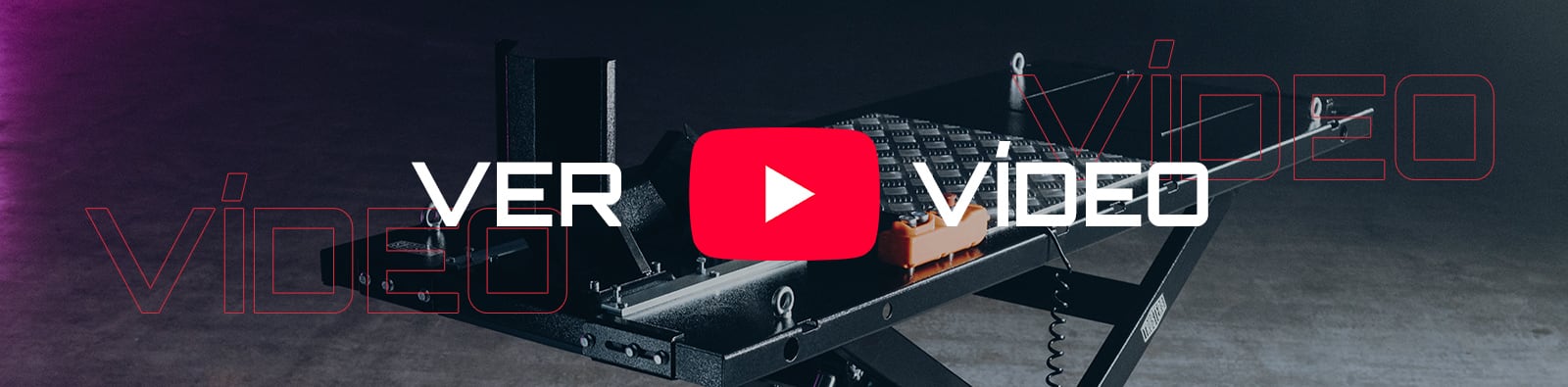 Icono de reproducción de YouTube rojo centrado sobre una mesa elevadora metálica con pedal naranja, texto grande VER VÍDEO en blanco y contornos rojos de la palabra VIDEO sobre un fondo industrial gris oscuro con iluminación morada a la izquierda