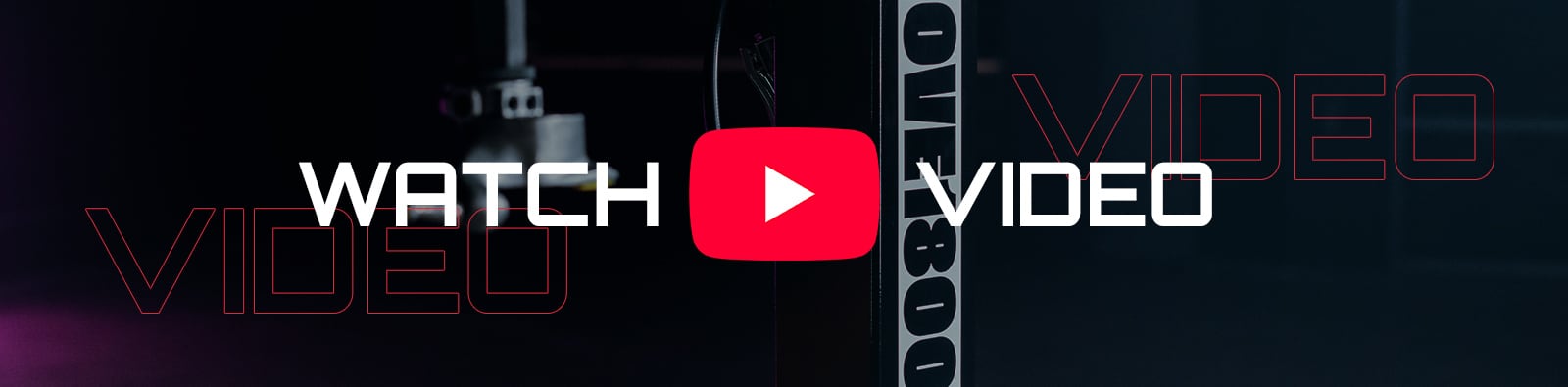 Dark horizontal banner with a red YouTube play button centered between white text WATCH and VIDEO, outlined VIDEO lettering on both sides and blurred studio camera equipment in the background