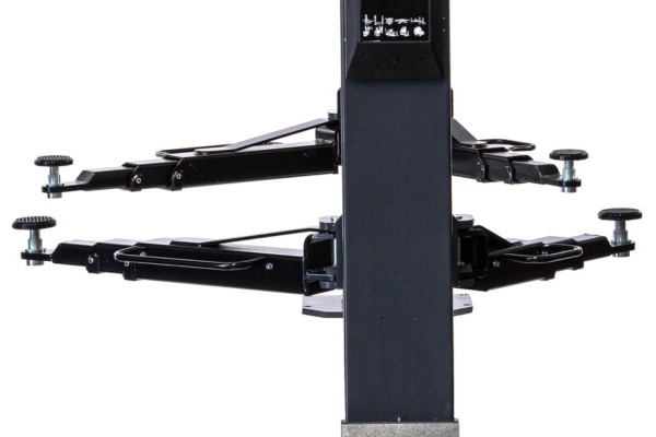 Close-up of the lower section of a vehicle lift: central vertical column with four adjustable black steel lift arms, each with round threaded height-adjustment pads, shown against a white background.