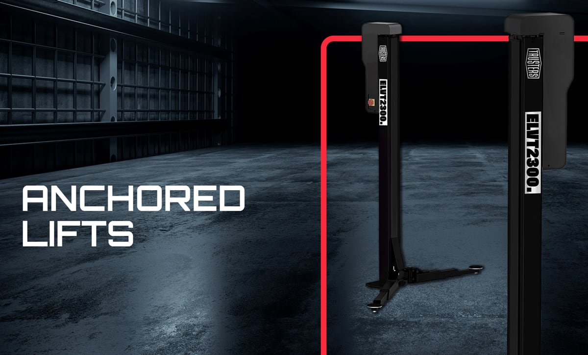 Two black anchored vehicle lift posts in a dim industrial garage with concrete floor, red accent line along the posts and large white text ANCHORED LIFTS on the left