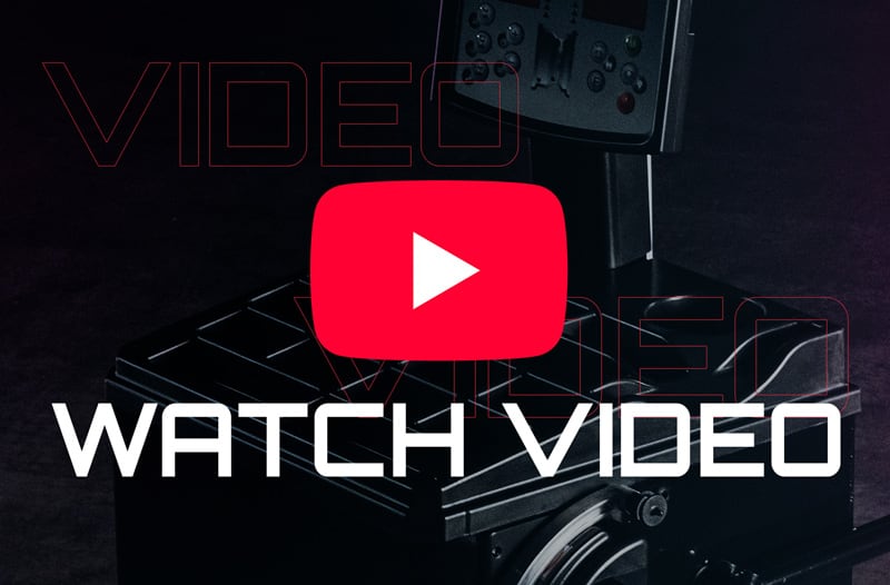 Red YouTube play button centered over a dark professional camera rig, large white WATCH VIDEO text across the lower half and faint outlined VIDEO text in the background
