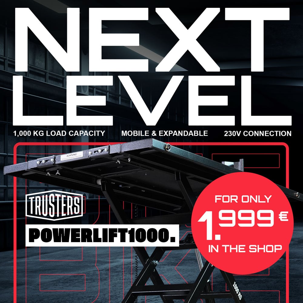 Promotional poster showing a black scissor lift table labeled POWERLIFT1000 and brand TRUSTERS, large NEXT LEVEL headline, specs 1,000 kg load capacity, mobile & expandable, 230V connection, red circle price €1,999.